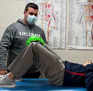 athletic trainer working with patient in laboratory
