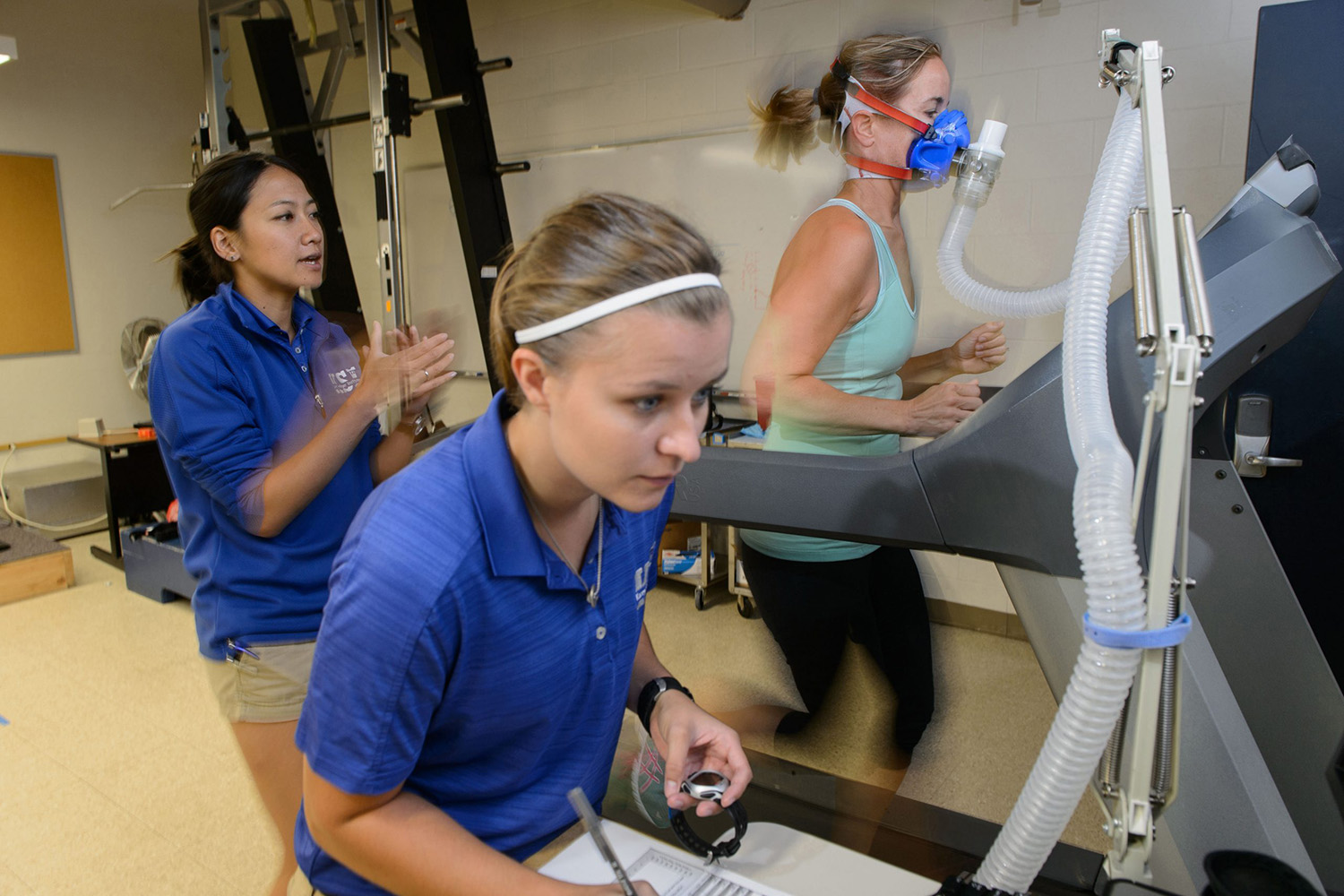 Woman checked for O2 levels on a treadmill