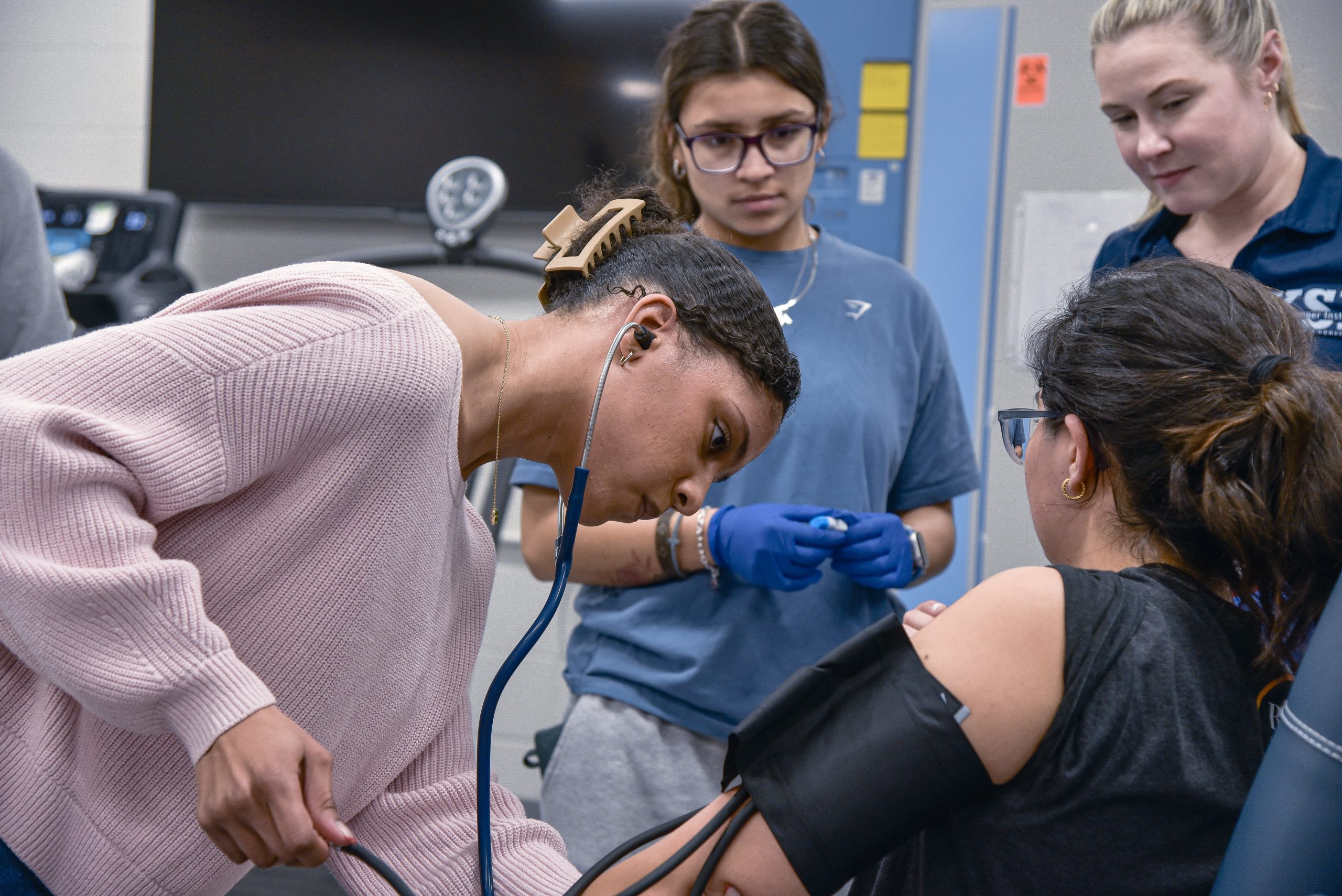 Students monitoring a patient's blood pressure